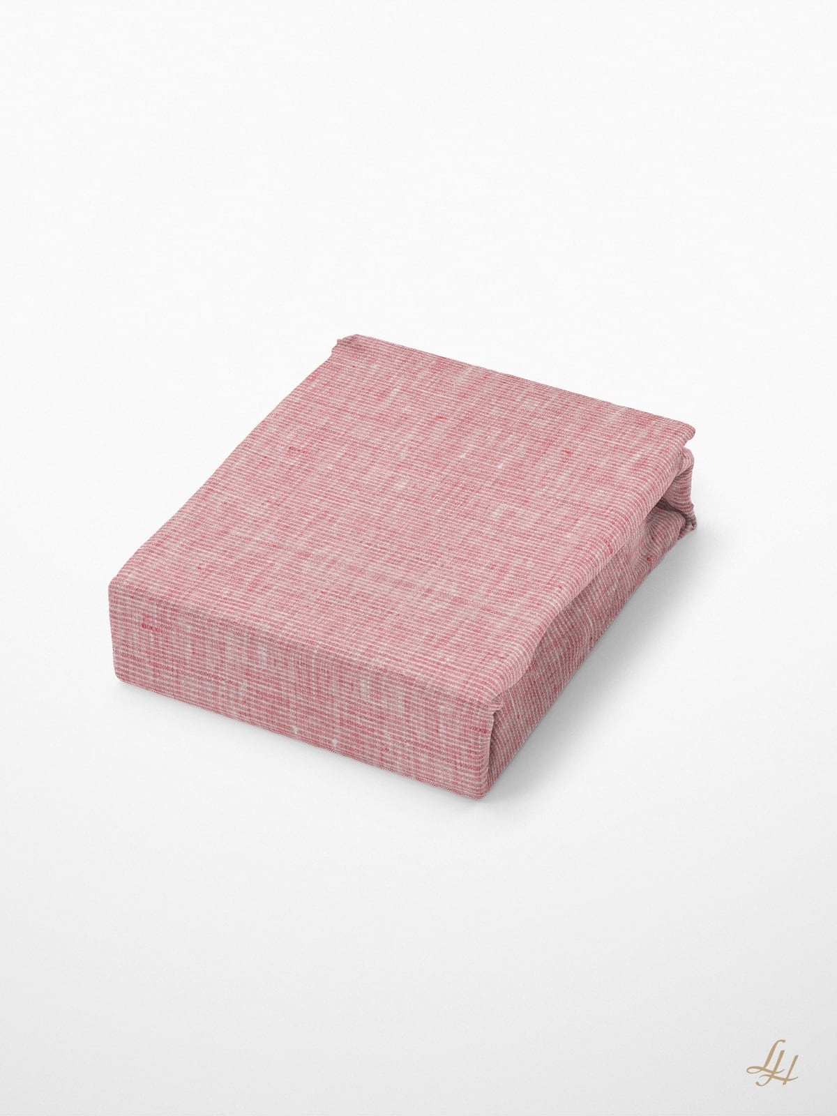 Ein rechteckiges Objekt, das wie eine Sommerdecke Leinen in strukturierten rosa Stoff eingewickelt ist, liegt auf einer schlichten weißen Fläche.